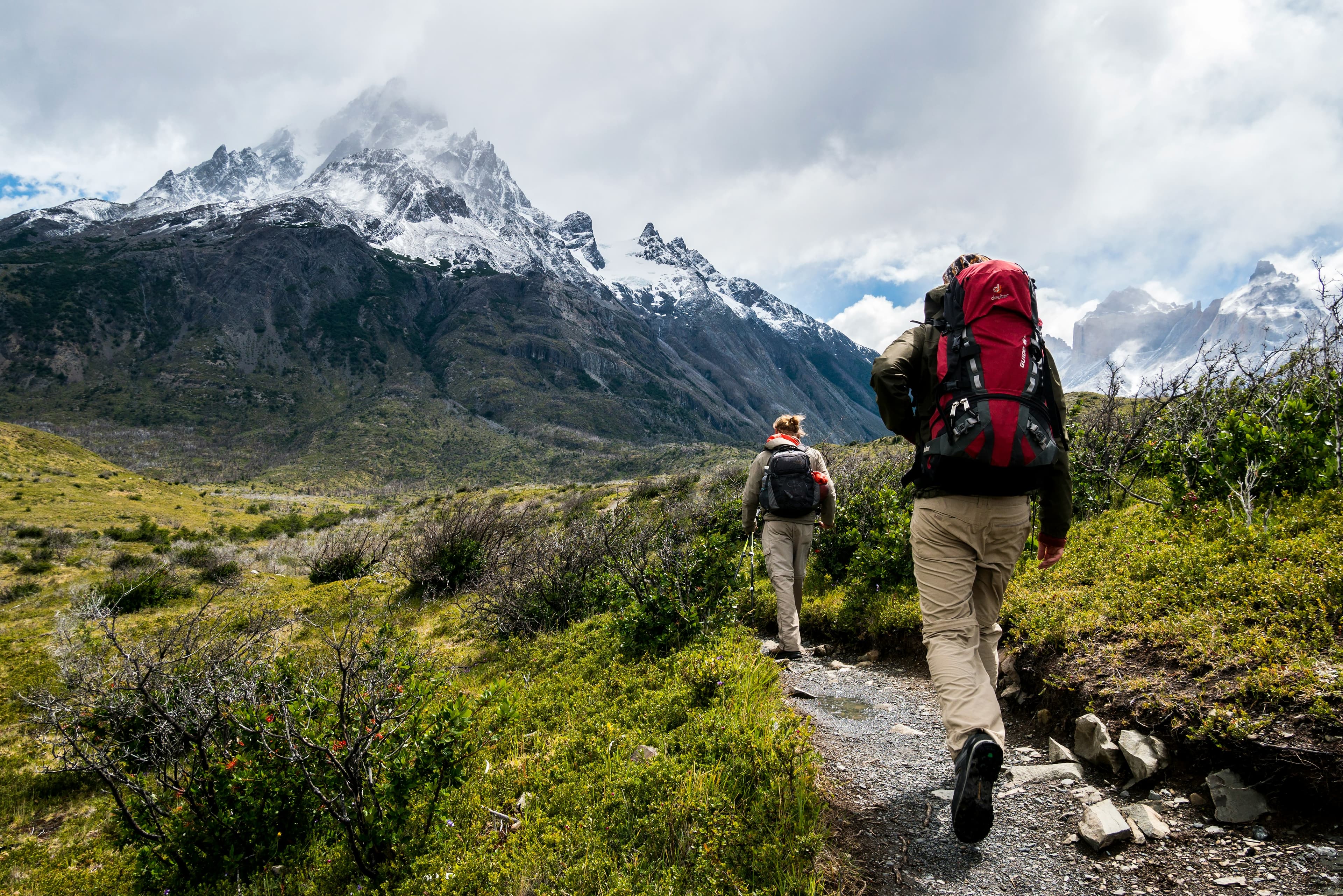 Two hikers with guide backpacks on a trail in Torres del Paine, Patagonia