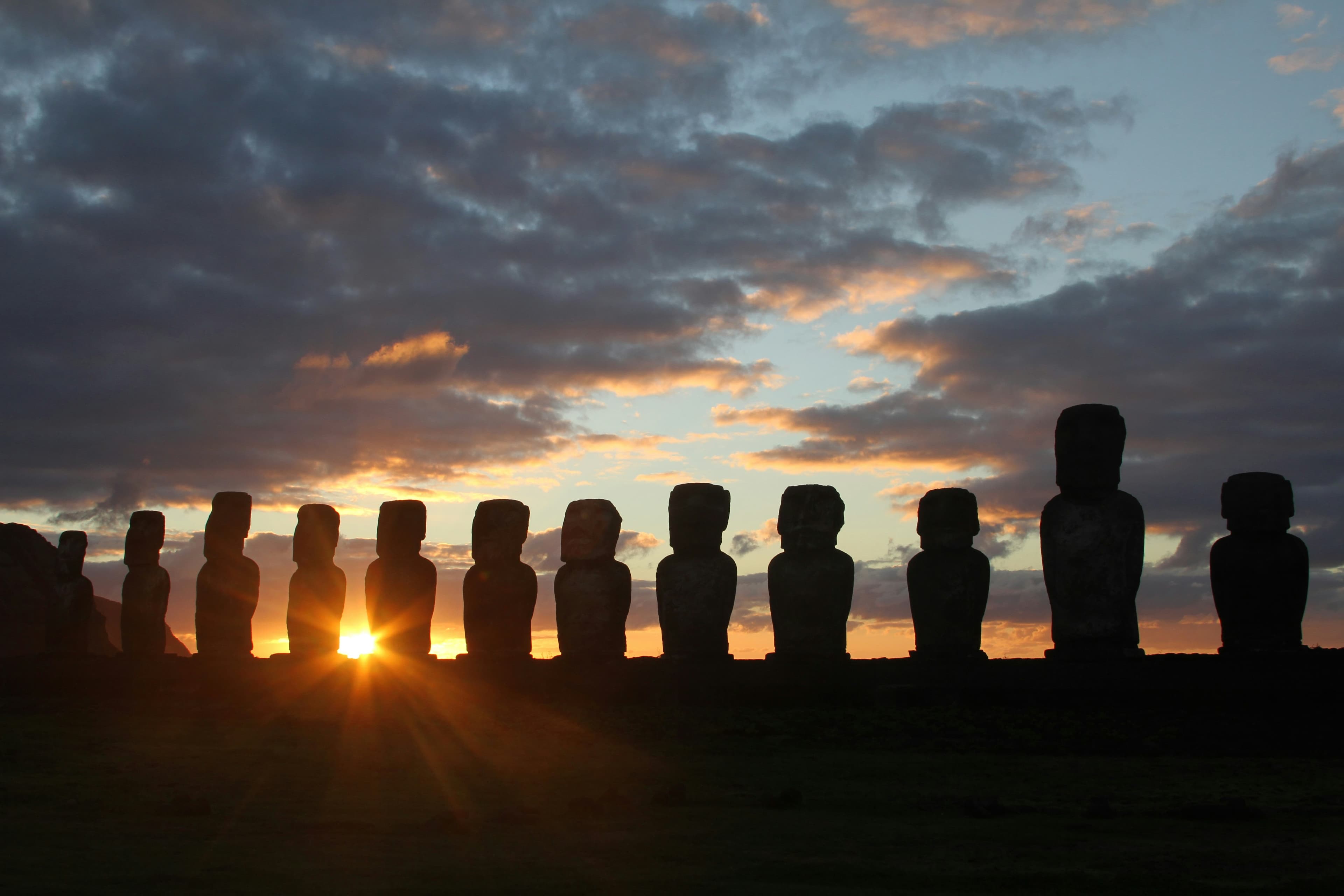 Moai statues at sunset on Rapa Nui, the kind of destination the trade currently prices around a hotel's stay